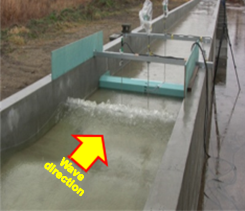 click to enlarge Fig. 1 Hydraulic model experiment for tsunami. The structure in the center of this image is a model based on a weir.